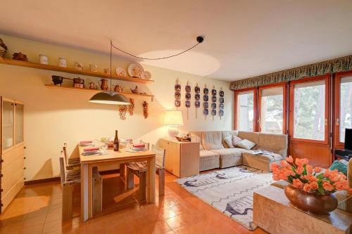 a living room with a table and a couch at Lo Stambecco - Duplex for 8 people - Happy Rentals in Bardonecchia