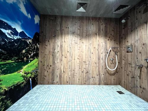 a bathroom with a shower with a painting on the wall at Hirschzauber A9 Montana Haus in Oberstdorf