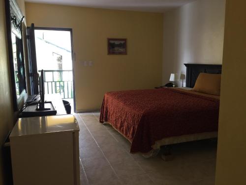 Postel nebo postele na pokoji v ubytování Hotel Las Caobas