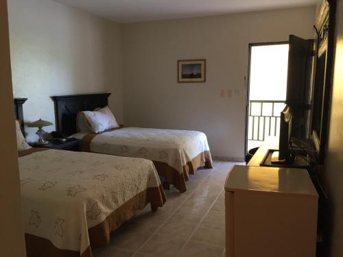 Postel nebo postele na pokoji v ubytování Hotel Las Caobas