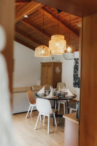 a dining room with a table and chairs and lights at City Bungalow in Schladming