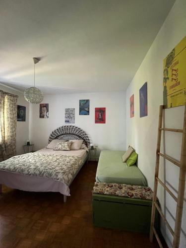 a bedroom with two beds and a ladder at Notre campagne provençale in Avignon