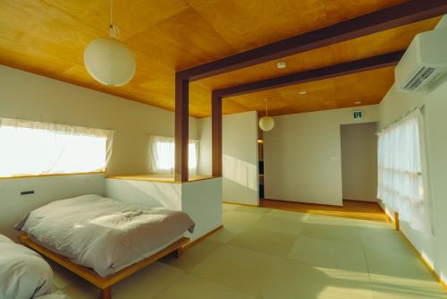 a bedroom with a bed and a wooden ceiling at 浬-kairi-1852 in Choshi