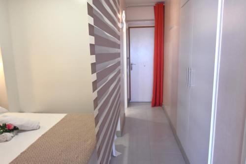 a hallway with a red curtain and a door at RNET - IR29218 Studios Roses Costa Brava in Roses