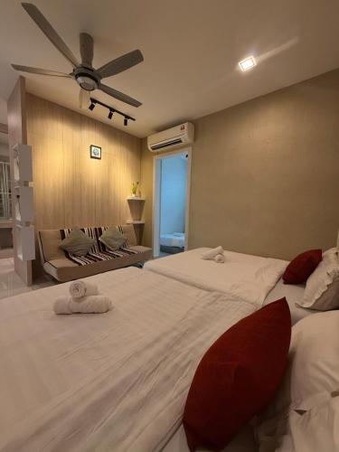 a bedroom with two beds and a ceiling fan at Seri Botani Private Pool Villa 5BR in Ipoh