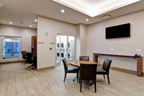 a conference room with a table and chairs and a flat screen tv at Canalta Kindersley in Kindersley