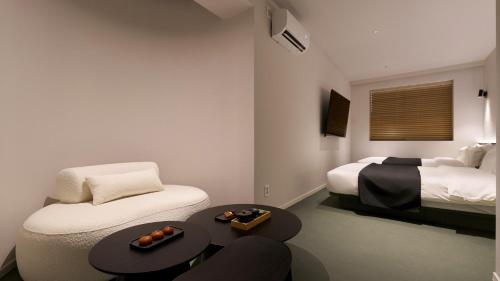 a room with two beds and a table and a couch at Anook Hotel Ulsan Mugeo in Ulsan