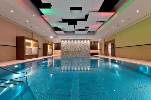a swimming pool with a waterfall in a hotel room at Radisson Blu Hotel, Bonn in Bonn