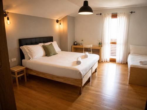 a bedroom with a large white bed and a table at Hotel Radis in Forni di Sotto