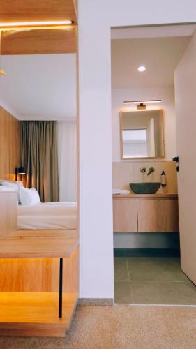 a hotel room with a bed and a sink at Marisel Escape Chalet in Mărişel
