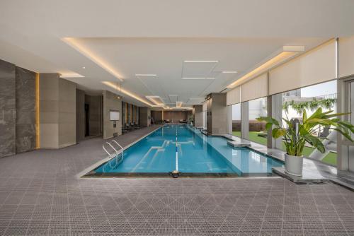 a large swimming pool in a building at JW Marriott Hotel Taiyuan in Taiyuan
