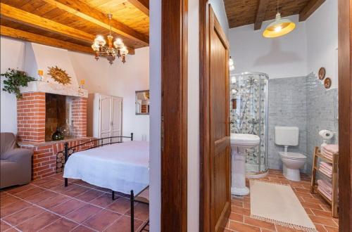 a bedroom with a bed and a bathroom at House Luca in Barban