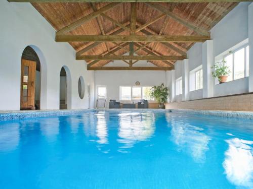 a large swimming pool with a wooden ceiling at Harvest - Ukc9523 in Barnstaple