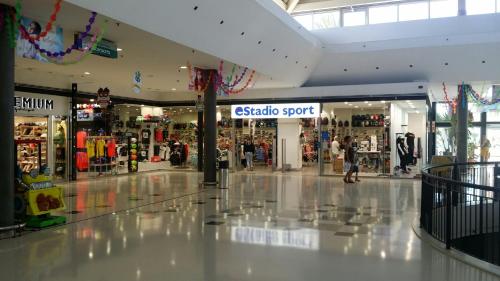 a shopping mall with a soto sport sign in the middle at Villa con Piscina ,Vista Mar y campo de golf in Caleta De Fuste