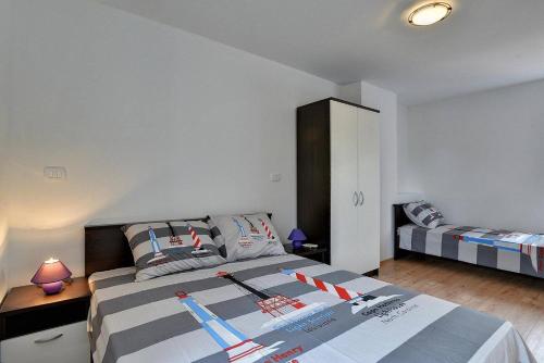 a bedroom with two beds and a cabinet in it at Villa BR in Ližnjan