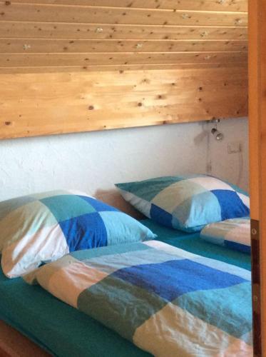 a bedroom with two beds and a wooden wall at Bavaria in Seeg