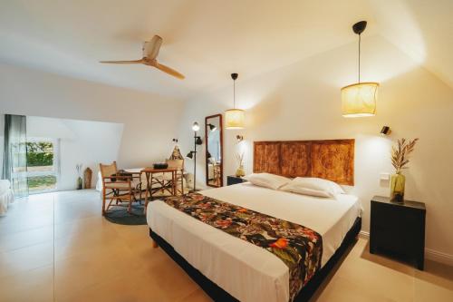 a bedroom with a bed and a dining room at Hôtel de la Brière et Restaurant Les Krapados in Saint-Lyphard