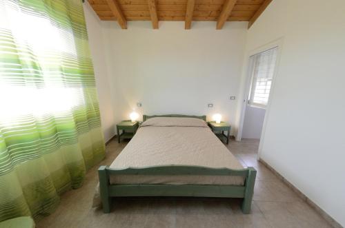 a bedroom with a bed in a room with windows at B&B Al Tardino in Sogliano al Rubicone