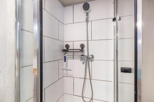 a shower with a shower head in a bathroom at Ferienwohnung am Eichhölzle in Wehr