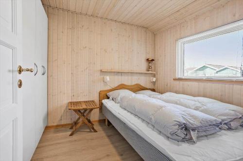 a bedroom with a bed in a room with a window at FY130-Middelfart-Stjernevej-117 in Middelfart
