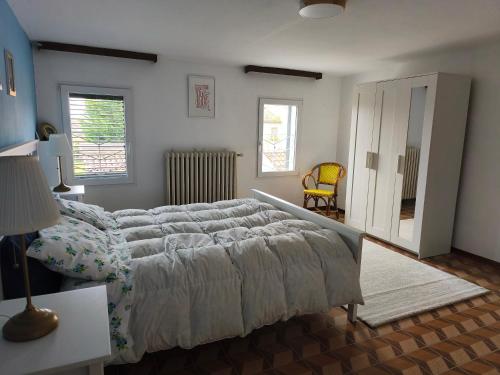 a bedroom with a large bed and a chair at Civico 18 in Caposotto