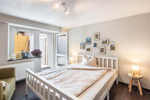 a bedroom with a white bed and a window at Ferienwohnung am Eichhölzle in Wehr