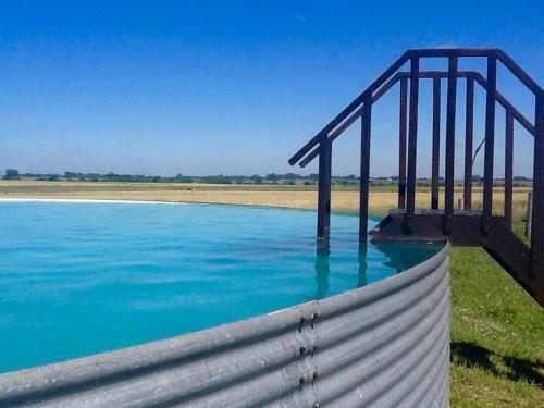 a bridge over a body of water at La Negrita Casa de Campo in Azcuénaga