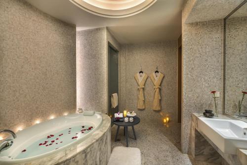 a bathroom with a tub and a sink at Sunrise On The Bund in Shanghai