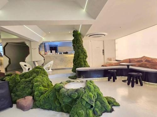 a room filled with lots of green vegetation at Big Tree Old Town Hotel in Chiang Mai