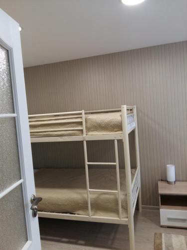 a bunk room with bunk beds in a room at Apartment with private entrance in Šilutė