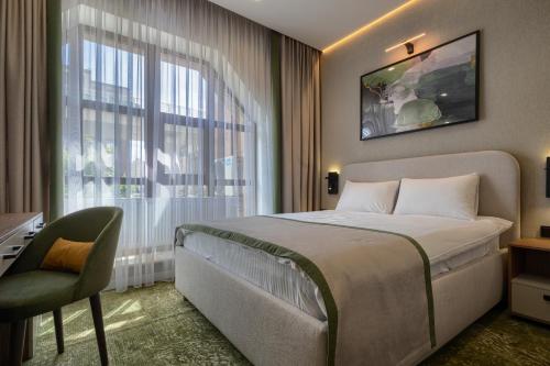 a hotel room with a bed and a window at City Line HOTEL in Astana