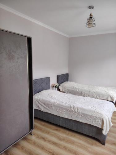 a bedroom with two beds and a flat screen tv at Sun ray in Ch'ik'unet'i