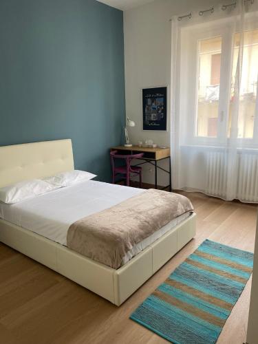 a bedroom with a bed and a table in it at Chagall Pascoli 10 in Asti