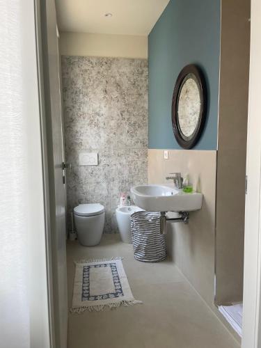 a bathroom with a sink and a toilet at Chagall Pascoli 10 in Asti