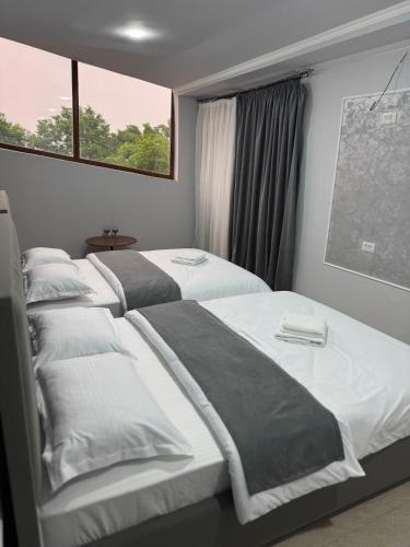a row of beds in a room with a window at Ararat hotel in Goris
