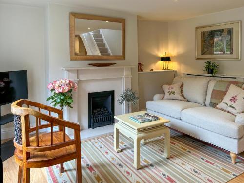 a living room with a couch and a fireplace at Militia Cottage in Marlborough
