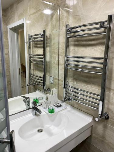 a bathroom with a white sink and a mirror at AlmaBagi Hotel&Villas in Quba