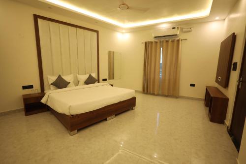 a bedroom with a large bed in a room at L Roy in Meerut