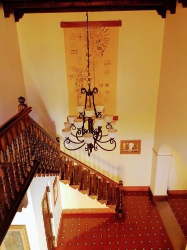 a staircase with a chandelier in a house at Casa Carmel Bed & Breakfast in Guatemala