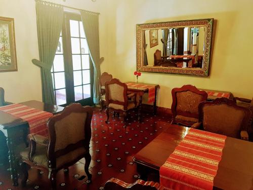 a room with chairs and a table and a mirror at Casa Carmel Bed & Breakfast in Guatemala