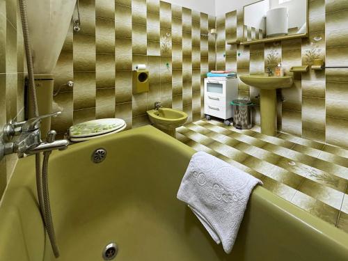 a bathroom with a green tub and a sink at Villa Four-bedroom Prcan Kotor in Prčanj