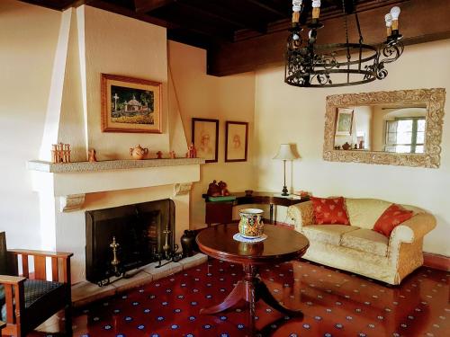 a living room with a couch and a fireplace at Casa Carmel Bed & Breakfast in Guatemala