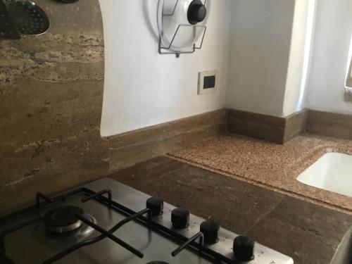 a kitchen with a stove and a counter top at Chalet fronte piscina in Zambra