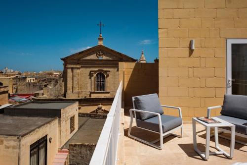 a pair of chairs sitting on the roof of a building at Casa Radiant in Rabat