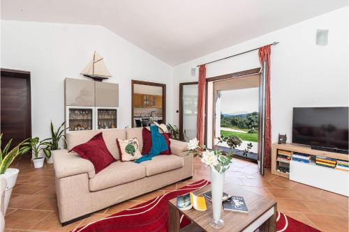 a living room with a couch and a tv at La Suara Manna - Happy Rentals in Telti