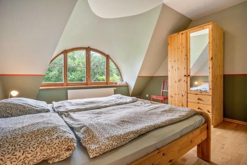 a bedroom with a bed and a large window at Alte Scheune in Putbus