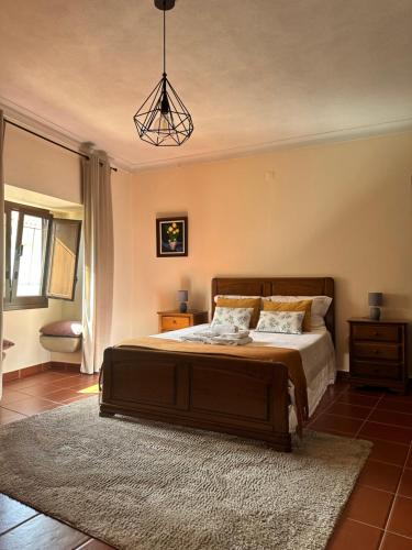 a bedroom with a large bed with a rug at Casa da Avó Ilda in Miranda do Douro