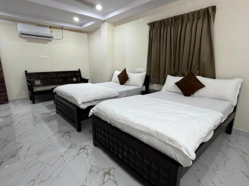 a bedroom with two beds and a piano at Sterlinge Homestay in Visakhapatnam