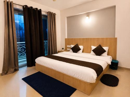 a bedroom with a large bed and a large window at krishna kunj stay in Mathura