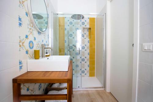 a bathroom with a sink and a shower at Pole Pole - SOLE in Agropoli